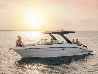 Friends aboard an SLX 280 at sunset